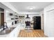 Modern kitchen with stainless steel appliances, white cabinets, and wood floors at 2495 Sedgefield Ave, Deltona, FL 32725