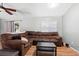 Spacious living room with wood floors, a large brown sectional, and natural light at 2495 Sedgefield Ave, Deltona, FL 32725