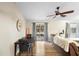 Open living area with wood floors, ceiling fan, and sliding glass doors at 2495 Sedgefield Ave, Deltona, FL 32725