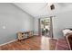 Bright living room with wood floors, slider door, and stylish media cabinet at 2495 Sedgefield Ave, Deltona, FL 32725