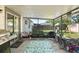 Covered wooden patio featuring string lights, chairs, and a view of the fenced-in backyard at 2495 Sedgefield Ave, Deltona, FL 32725