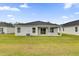 The backyard features a well-maintained lawn and contemporary home design at 5577 Creek Haven Way, Lakeland, FL 33810