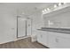 Modern bathroom featuring double sinks, granite countertops, a glass-enclosed shower, and white cabinets at 5577 Creek Haven Way, Lakeland, FL 33810