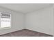 The bedroom has neutral carpet, a window with blinds, and is freshly painted at 5577 Creek Haven Way, Lakeland, FL 33810