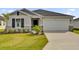 Charming single-story home featuring a well-manicured lawn, two car garage and a welcoming entrance at 5577 Creek Haven Way, Lakeland, FL 33810