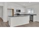 Modern kitchen featuring white cabinetry, stainless steel appliances, and granite countertops at 5577 Creek Haven Way, Lakeland, FL 33810