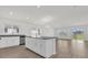 Open kitchen with an island, stainless steel dishwasher, granite counters and direct access to the living area at 5577 Creek Haven Way, Lakeland, FL 33810