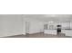 Bright, open-concept living room and kitchen with white cabinets and hardwood floors at 5577 Creek Haven Way, Lakeland, FL 33810