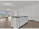 Spacious room with wood flooring, a modern chandelier, and view to the back yard at 5577 Creek Haven Way, Lakeland, FL 33810