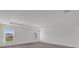 A large, bright primary bedroom with a tray ceiling, carpet floors, and natural light at 5577 Creek Haven Way, Lakeland, FL 33810