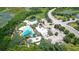 Aerial view of community pool, clubhouse, and surrounding landscape at 154 Captiva Dr, Davenport, FL 33896