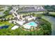 Aerial view of community pool, clubhouse, and surrounding landscape at 154 Captiva Dr, Davenport, FL 33896