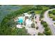 Aerial view of community pool, clubhouse, and surrounding landscape at 154 Captiva Dr, Davenport, FL 33896