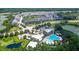 Aerial view of community pool, clubhouse, and surrounding landscape at 154 Captiva Dr, Davenport, FL 33896