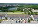 Aerial view of townhouses with parking and a nearby lake at 154 Captiva Dr, Davenport, FL 33896