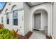 Townhouse entrance with gray door and arched entryway at 154 Captiva Dr, Davenport, FL 33896