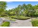 Landscaped putting green with palm trees and lush greenery at 154 Captiva Dr, Davenport, FL 33896