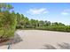 Outdoor sand volleyball court with net and surrounding landscaping at 154 Captiva Dr, Davenport, FL 33896