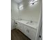 Bathroom with double sink vanity, modern lighting and hardware at 29 W 17Th St, Apopka, FL 32703