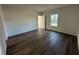 Bright bedroom with wood-look flooring, white walls, and a window at 29 W 17Th St, Apopka, FL 32703