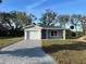 Charming single-story home with a well-manicured front yard and a gray brick driveway at 29 W 17Th St, Apopka, FL 32703