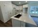 Stylish kitchen featuring a quartz island, and white cabinetry at 29 W 17Th St, Apopka, FL 32703