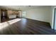 Open-concept living room featuring wood-look floors, with kitchen, and outdoor views at 29 W 17Th St, Apopka, FL 32703