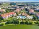 Aerial view of community featuring a large pool, splash park, clubhouse, apartments, green space, and a pond at 4114 Breakview Dr # 406, Orlando, FL 32819