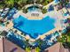 Aerial view of a large community pool featuring umbrellas and lounge chairs in a luxurious outdoor setting at 4114 Breakview Dr # 406, Orlando, FL 32819
