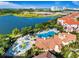 An aerial view showcasing a large pool, splash park, landscaping and a lake in the distance in the community at 4114 Breakview Dr # 406, Orlando, FL 32819
