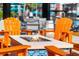 Modern outdoor fire pit surrounded by comfortable orange Adirondack chairs, creating an inviting space at 4114 Breakview Dr # 406, Orlando, FL 32819