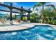 Sparkling community hot tub with sunshade, lounge seating, and manicured landscaping at 4114 Breakview Dr # 406, Orlando, FL 32819
