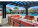 Resort-style community pool, covered seating, and lounge chairs with tropical surroundings at 4114 Breakview Dr # 406, Orlando, FL 32819
