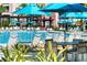 Resort-style community pool showcasing numerous chairs, tables, and umbrellas at 4114 Breakview Dr # 406, Orlando, FL 32819