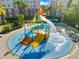 Vibrant splash pad with yellow slides, orange stairs, and a large tipping bucket providing Gathering fun at 4114 Breakview Dr # 406, Orlando, FL 32819