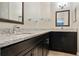 Modern bathroom with granite countertop and dark cabinets at 2472 Temple Grove Ln, Kissimmee, FL 34741