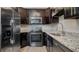 Stainless steel appliances and dark wood cabinets in kitchen at 2472 Temple Grove Ln, Kissimmee, FL 34741