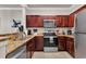 Well-lit kitchen with stainless steel appliances, ample cabinets, and granite countertops at 1301 Tuscan Ter # 9303, Davenport, FL 33896