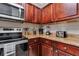 Close-up of kitchen area featuring stainless steel appliances and granite countertops at 1301 Tuscan Ter # 9303, Davenport, FL 33896