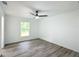 Bedroom with wood-look floors, ceiling fan and window at 1541 Nw Buena Vista Rd, Dunnellon, FL 34431