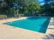 Community pool surrounded by lush landscaping and comfortable seating at 1994 Kenaston Rd # 1994, Maitland, FL 32751