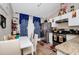 Well-lit kitchen with stainless steel appliances, white cabinets, granite countertops, and cozy dining area at 5003 Aventura Blvd, Orlando, FL 32839