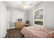 Bedroom with wood floors, window, and dresser at 2526 Nobleman Ct, Windermere, FL 34786