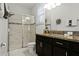 Bathroom with walk-in shower and granite countertop at 5431 Solterra Cir, Davenport, FL 33837