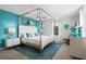 Main bedroom with a teal accent wall and a king-size bed at 5431 Solterra Cir, Davenport, FL 33837