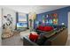 Fun Star Wars themed game room with sectional sofa and large TV at 5431 Solterra Cir, Davenport, FL 33837