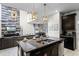 Kitchen island with granite countertop and seating at 5431 Solterra Cir, Davenport, FL 33837