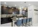 Updated kitchen with dark cabinetry, granite countertops, and breakfast bar at 5431 Solterra Cir, Davenport, FL 33837