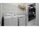 Laundry room with washer, dryer, and kitchen view at 5431 Solterra Cir, Davenport, FL 33837