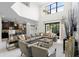 Spacious living room with high ceilings, a large sectional sofa, and a modern chandelier at 5431 Solterra Cir, Davenport, FL 33837